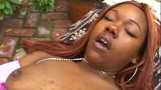 Two ebony lesbians fucking with dildos outdoors